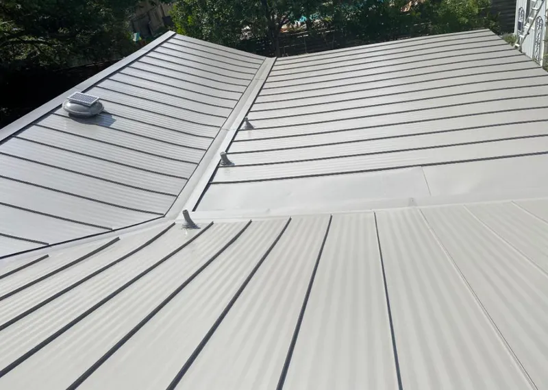 Solar attic fan installed on a metal roof for Roof Ventilation in Cannon